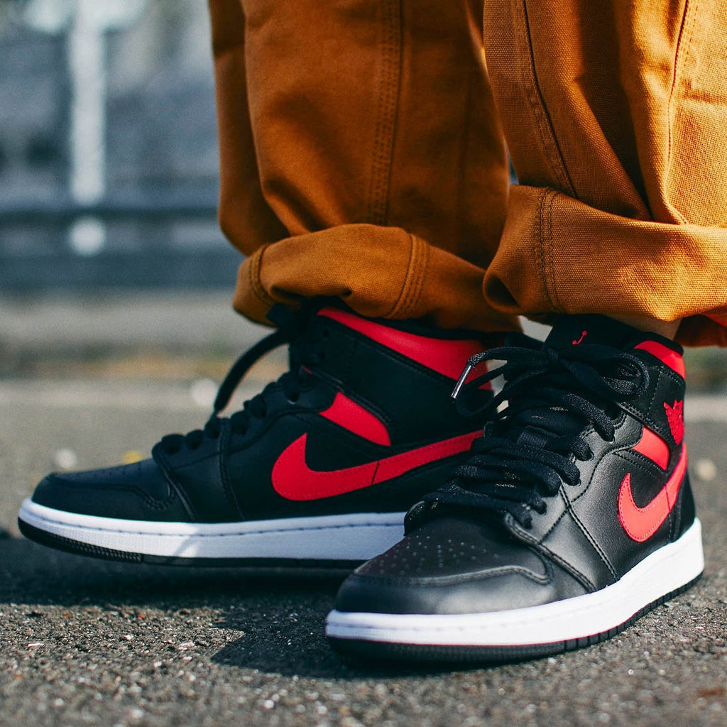 This Shadow-Like Air Jordan 1 Mid Features Red Accents